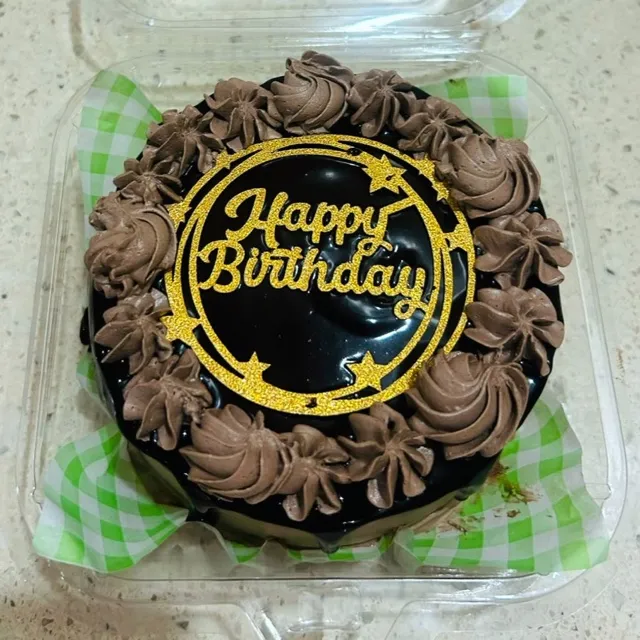 A Gluten-Free Chocolate Cake — A gluten-free chocolate cake finished with piped chocolate rosettes and a glittered gold topper.