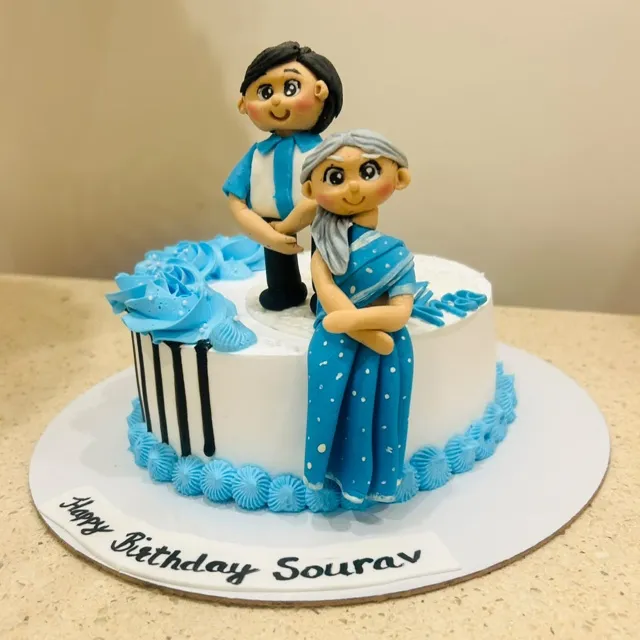 A Fondant-Topper Birthday Cake — A hand-sculpted fondant topper brings the birthday message to life, finished with piped blue rosettes and a hand-lettered plaque.