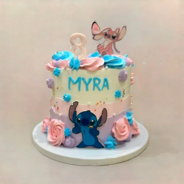A Lilo & Stitch Birthday Cake for Myra — A pastel ombre cake with Stitch and Angel toppers, piped rosettes, and a hand-lettered name and age.