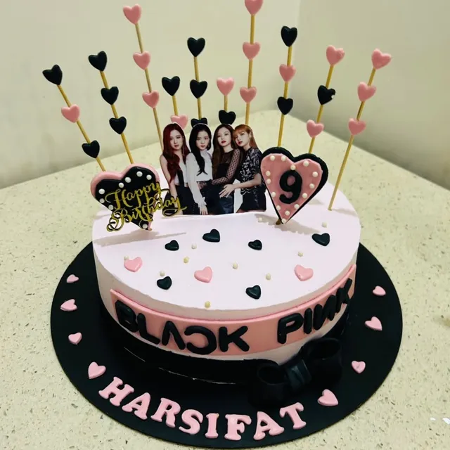 A BLACKPINK Birthday Cake — A BLACKPINK-themed cake with a printed edible topper, piped hearts on skewers, and hand-lettered fondant lettering.